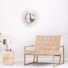 Elegant soffbord med guldram och rosa tyg i modern inredning.