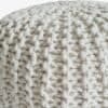 Grovt stickad sittpuff i naturfärgad ull, 45 cm diameter.
