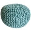 Stickad sittpuff i blått, rund och grovt stickad design.