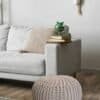 Bekväm sittpuff i beige med stickad design för hemmet.