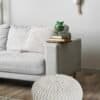 Handknuten pall pouf i grovt stickad design, perfekt som sittplats eller dekorativt inslag.