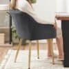 Klädd stol med armstöd i vardagsrummet, modern design och bekvämt sittande.