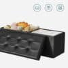 Svart foldbar ottoman med leksaker och förvaringsutrymme.