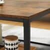 Stilrent soffbord i industriell design med rustik brun yta och svart metallram.