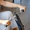 Person som tränar med rörelseträning cykel för armar och ben.