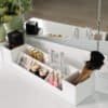Makeup organizer with brushes, lipsticks, and mirror for beauty routines.