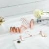 Elegant rose gold metal hangers with clips for skirts and trousers.