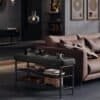 Elegant living room with black coffee table, sofa, and wall art.